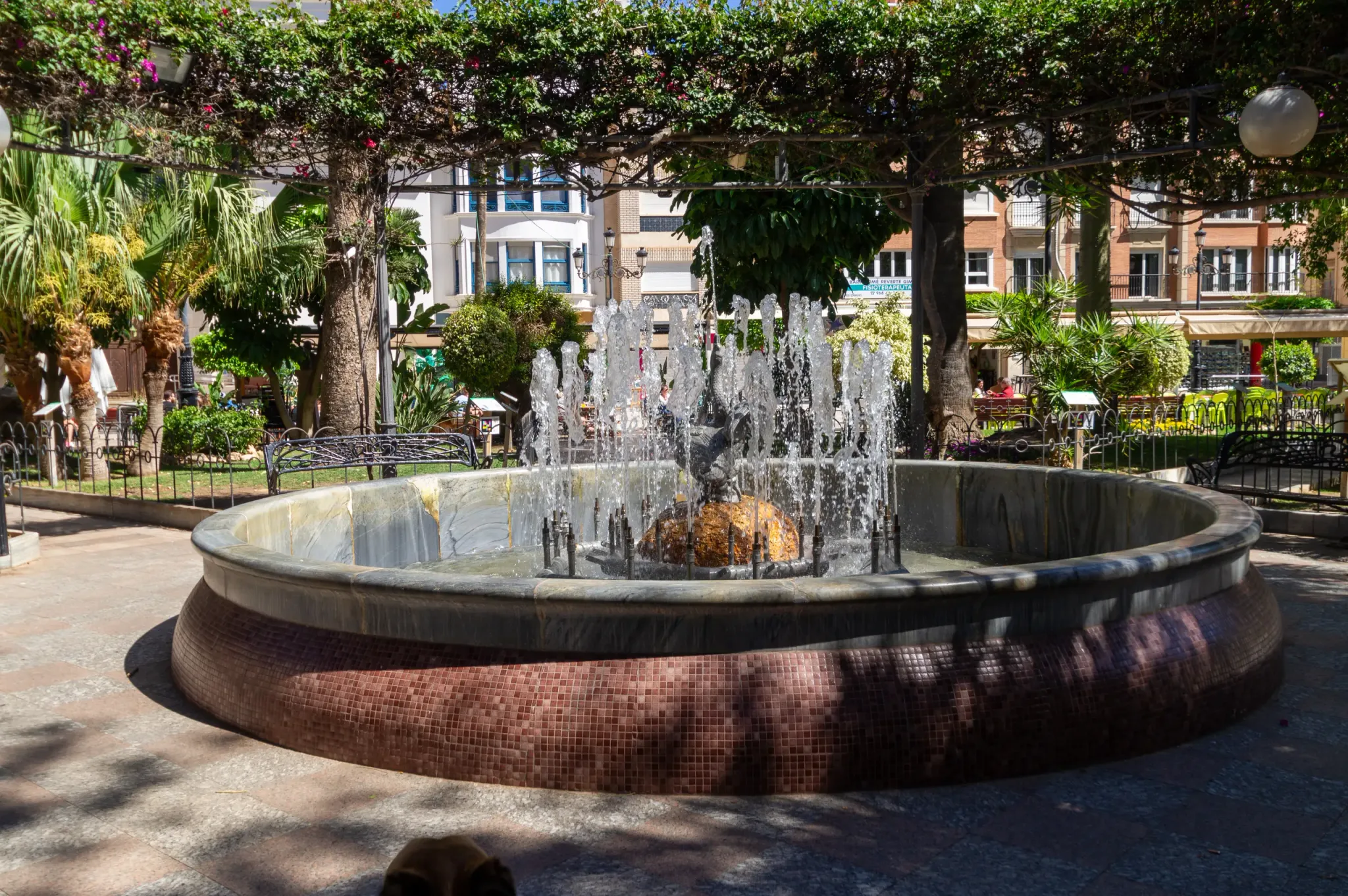 Circular fountain in a landscaped Águilas plaza