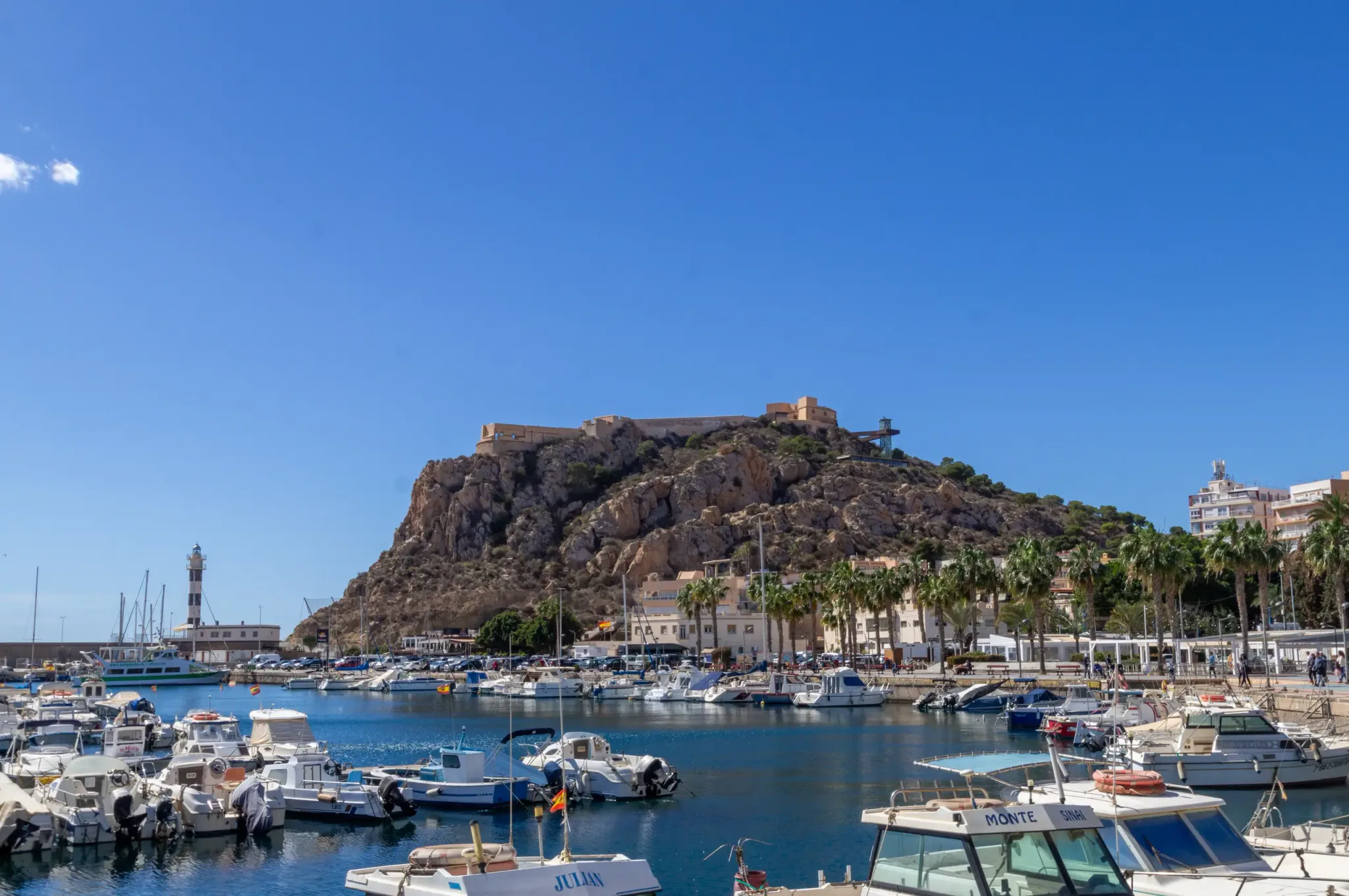 Boats in Águilas marina beneath the hilltop castle