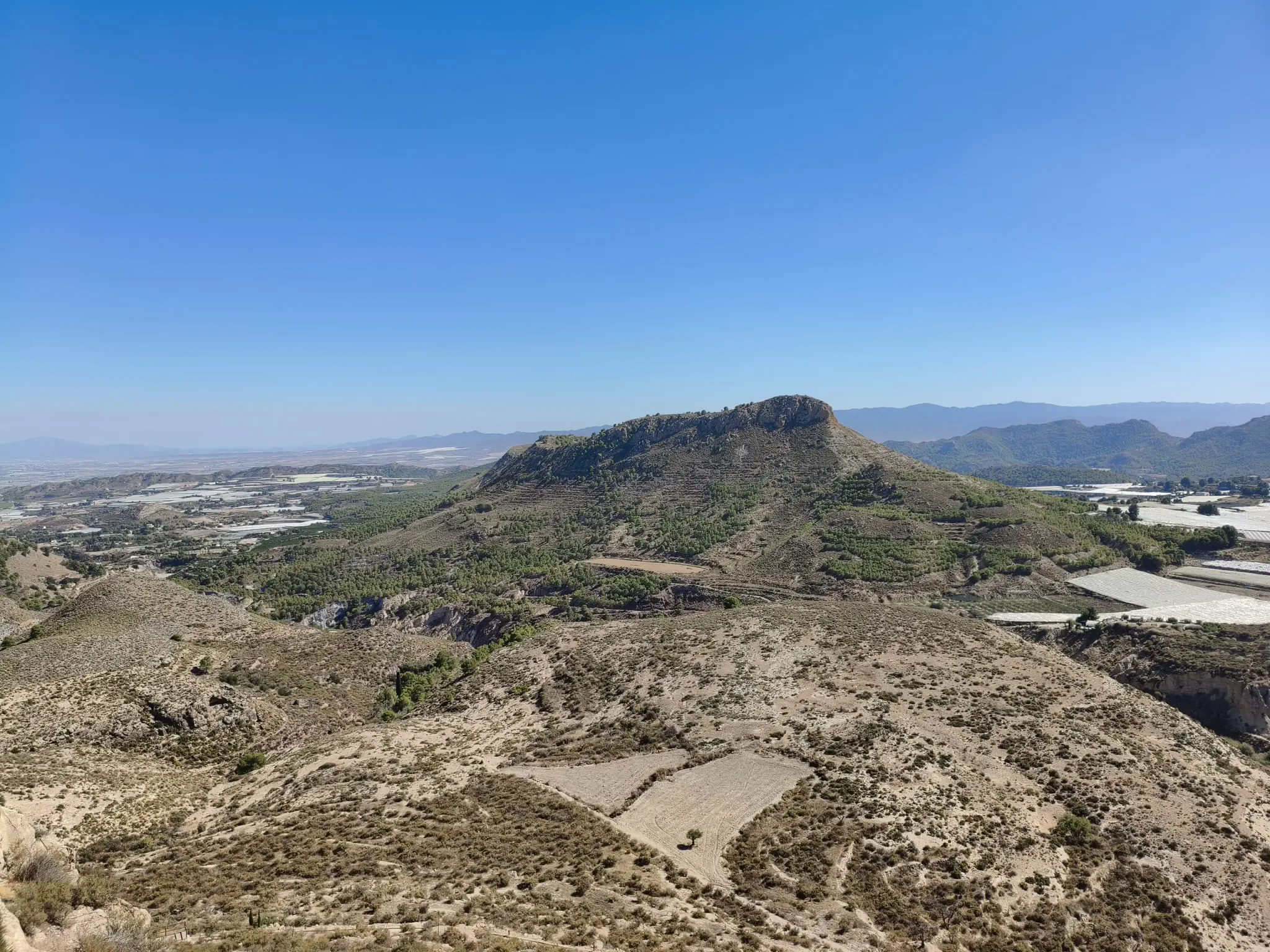 Rocky countryside and distant mountains seen from Aledo Castle