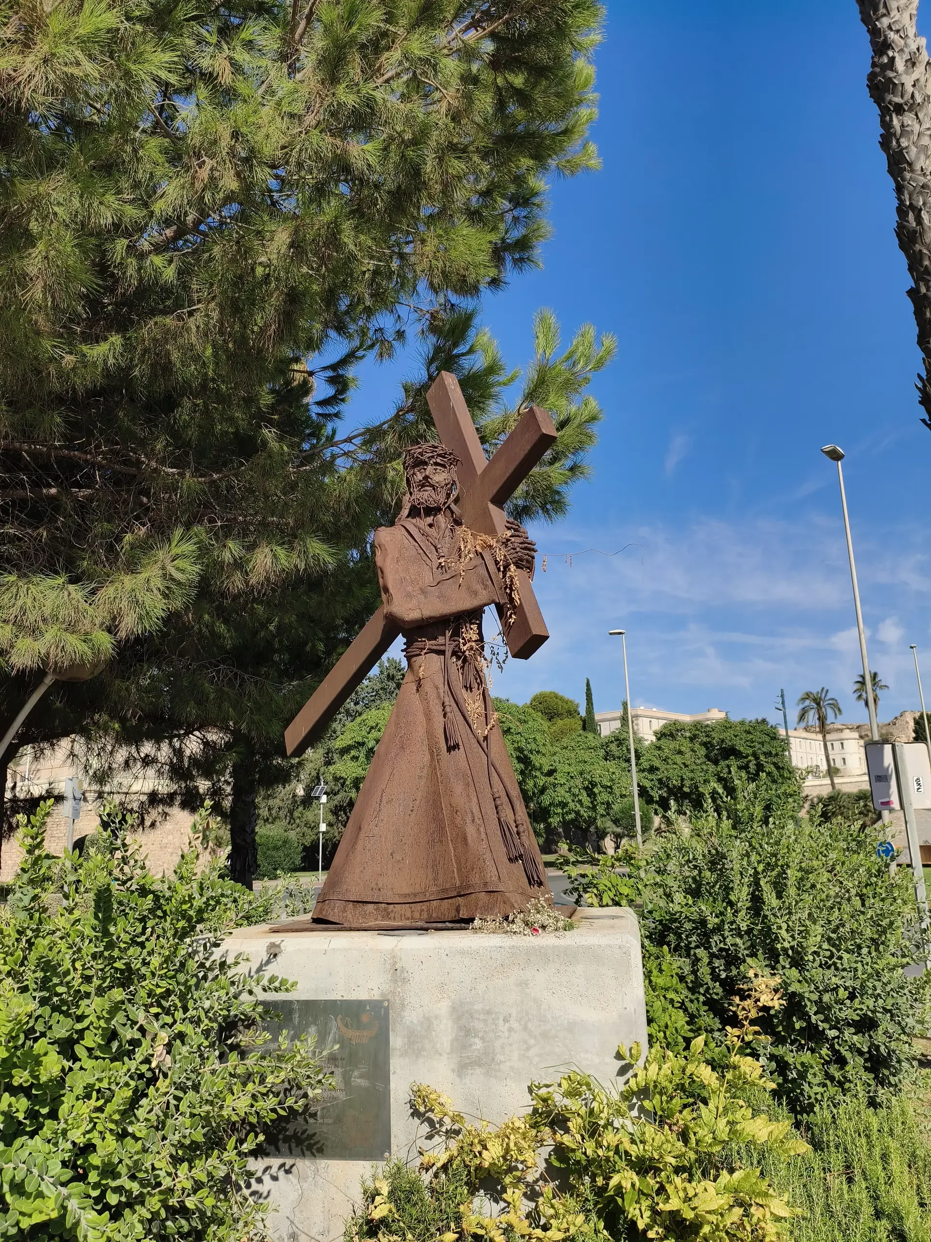 Figurine en métal portant une croix surélevée dans un jardin de Carthagène