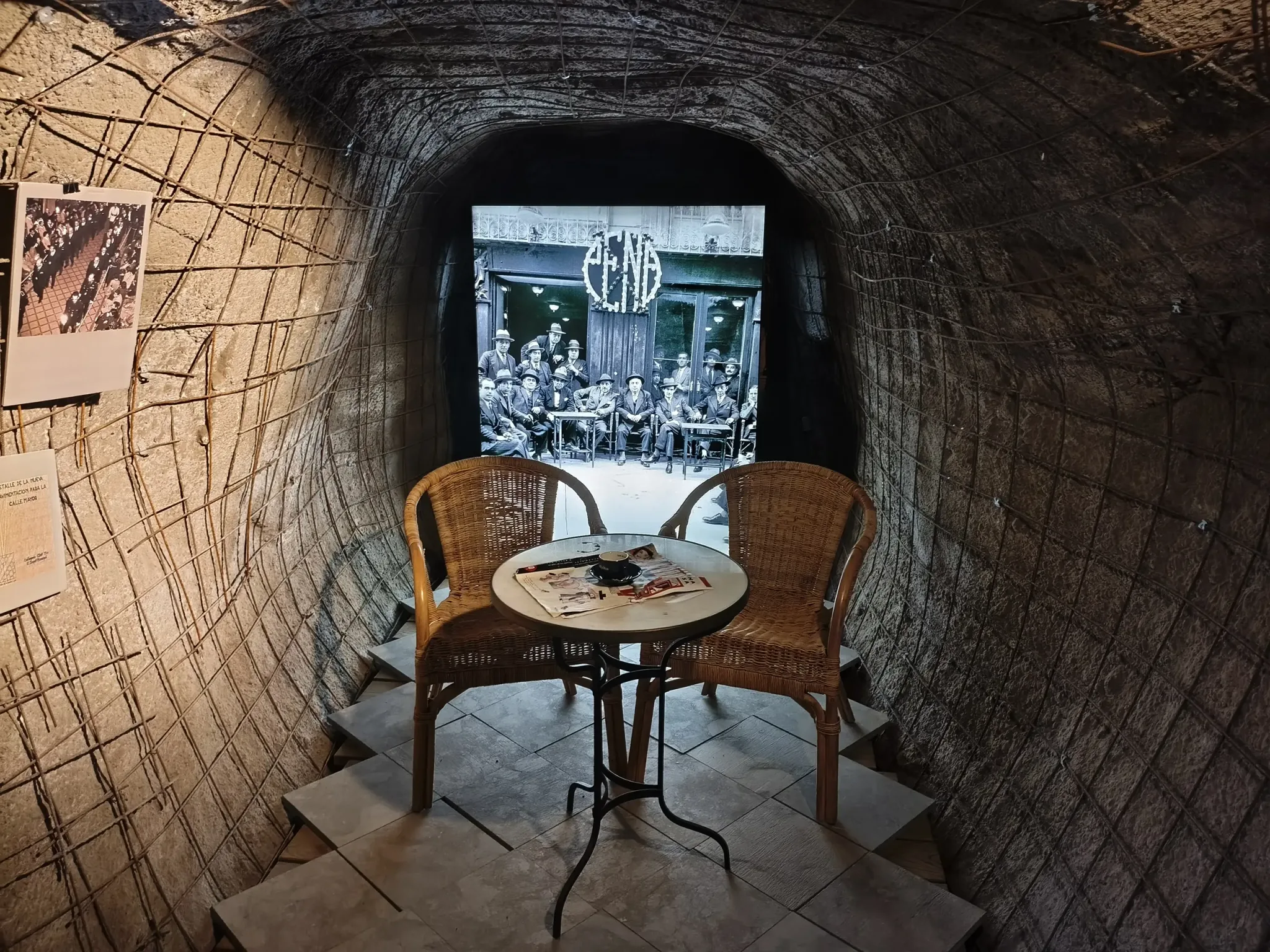 Small table and chairs used in an exhibition scene inside the shelter