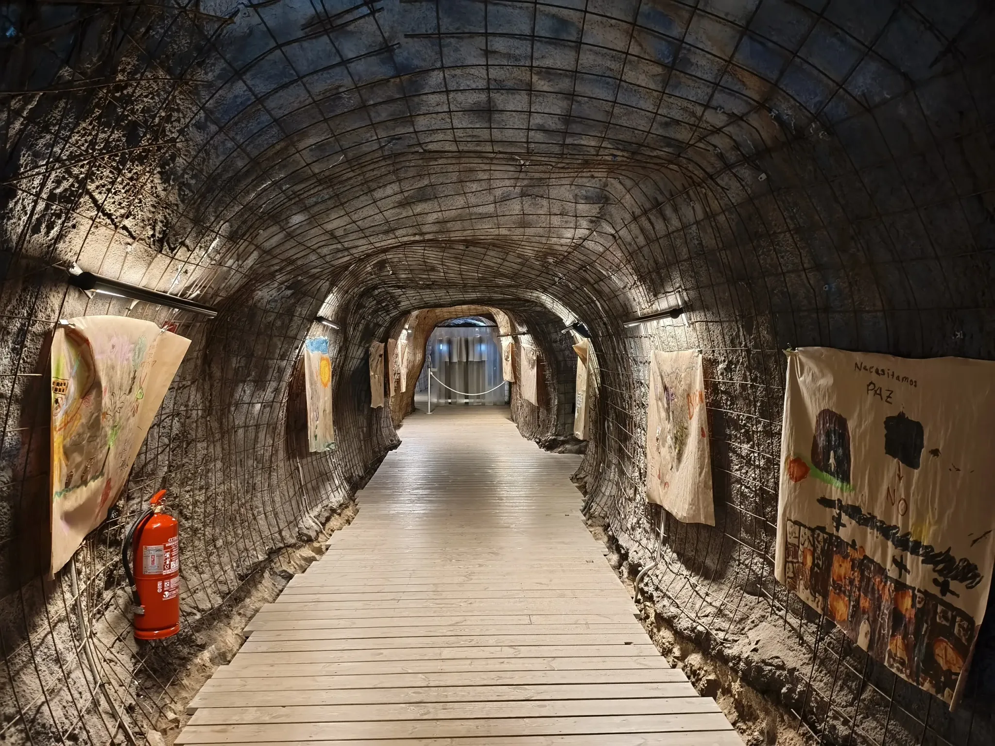 Long illuminated tunnel lined with exhibition panels