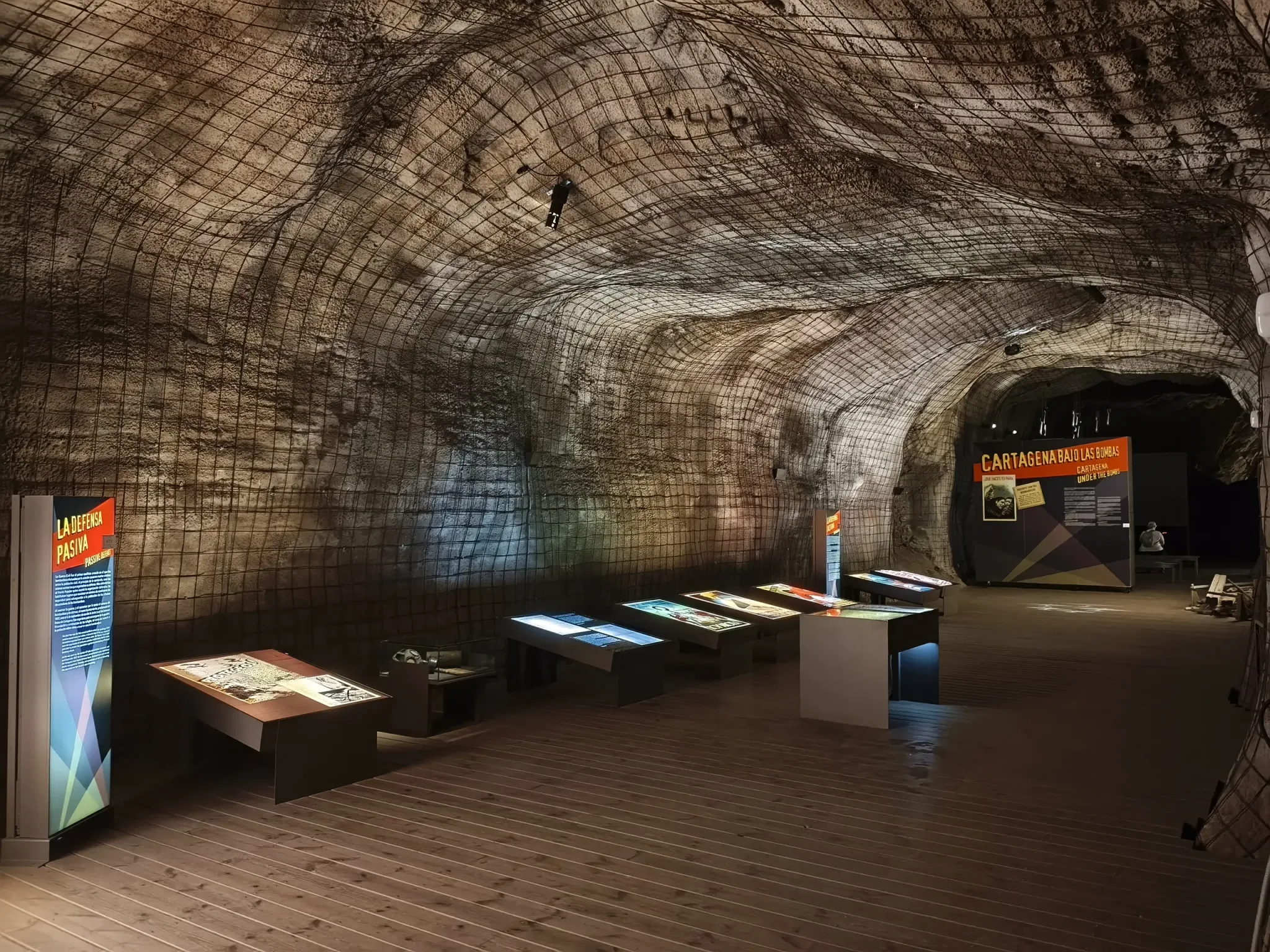 Wide rock-cut gallery with displays inside Cartagena's Civil War Air Raid Shelter Museum