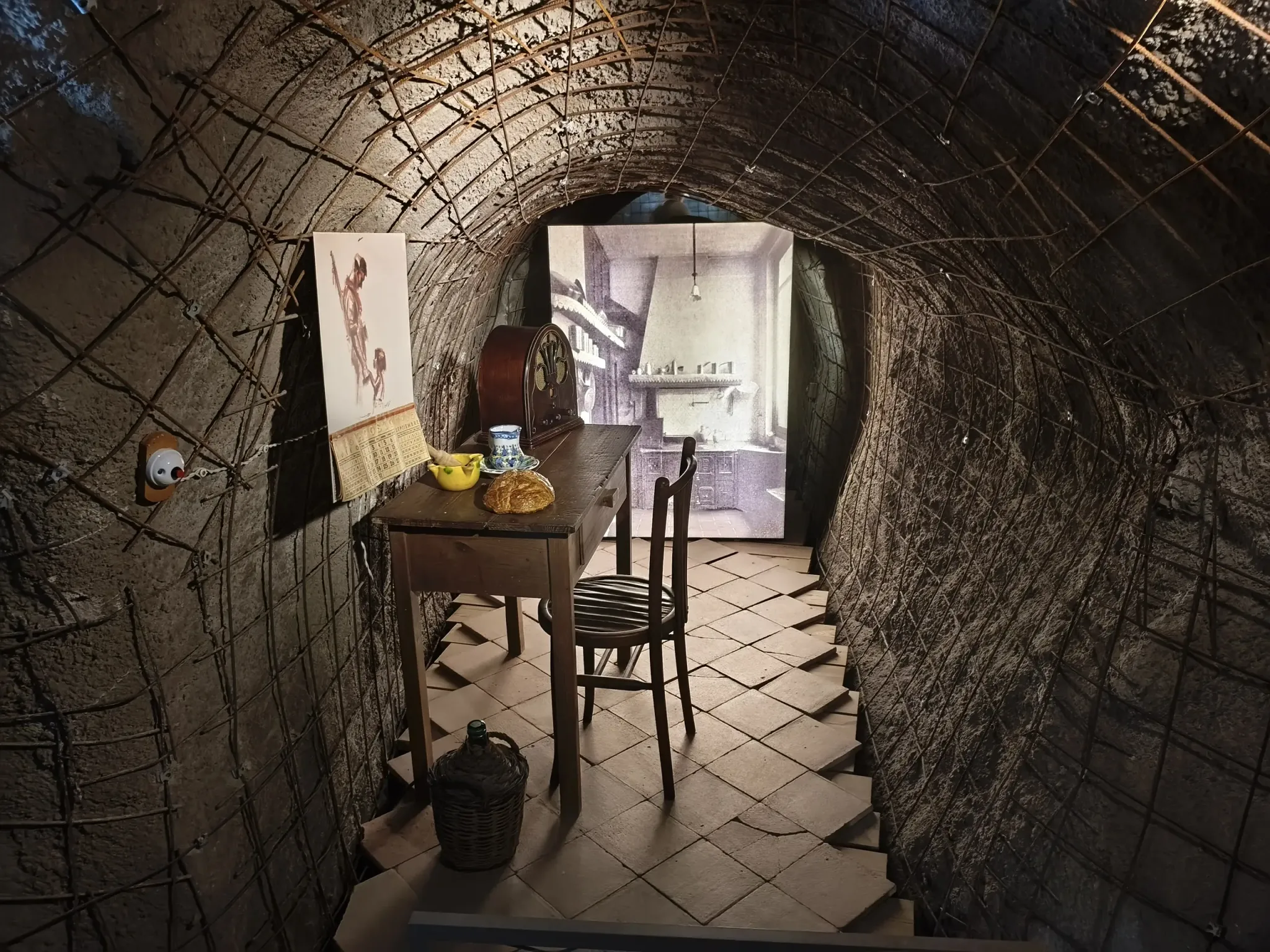 Reconstructed domestic table scene inside a shelter gallery