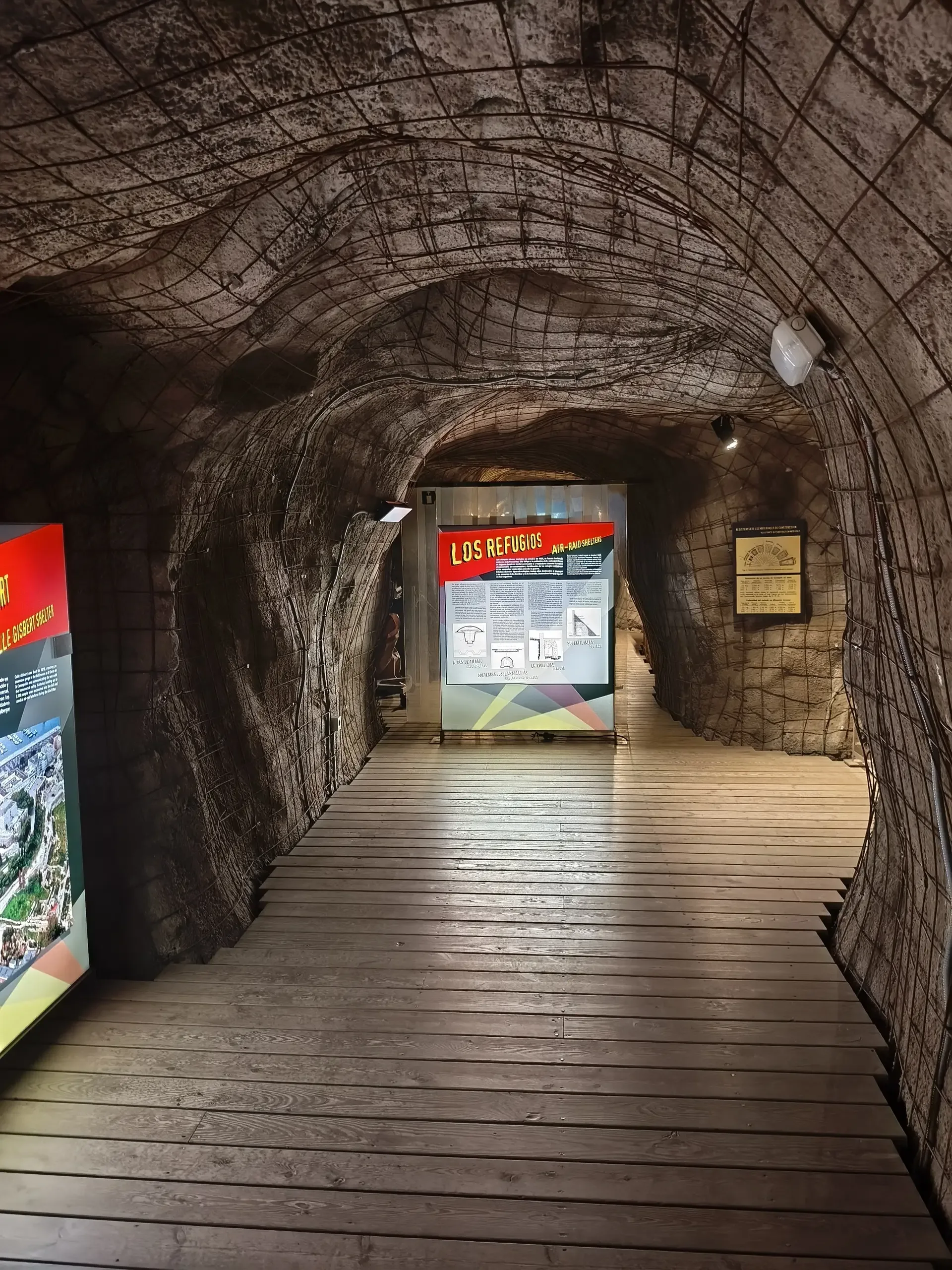 Rock-cut gallery with illuminated visitor panels