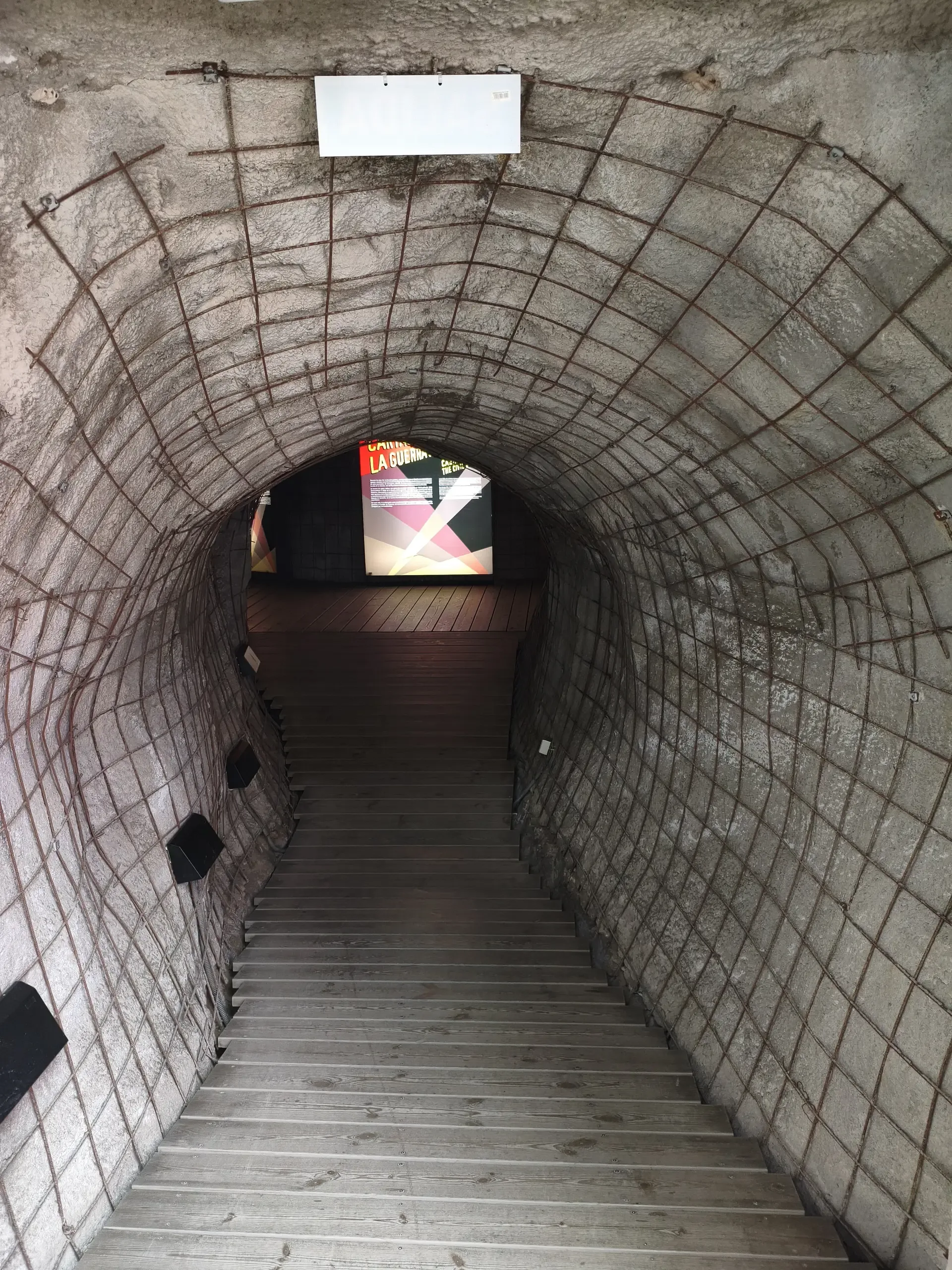 Narrow vaulted shelter passage leading towards daylight