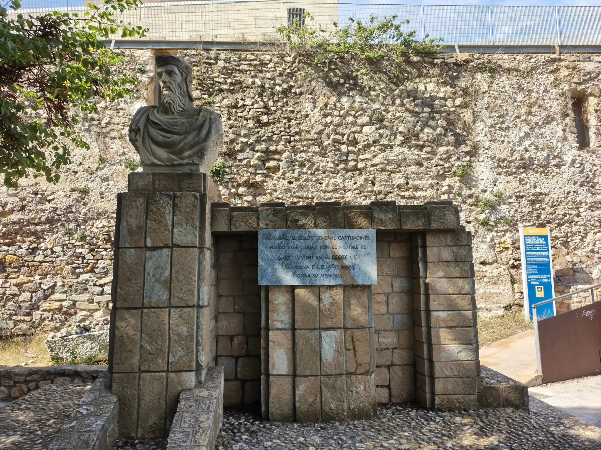 Stone entrance to Concepción Castle with visitor signs