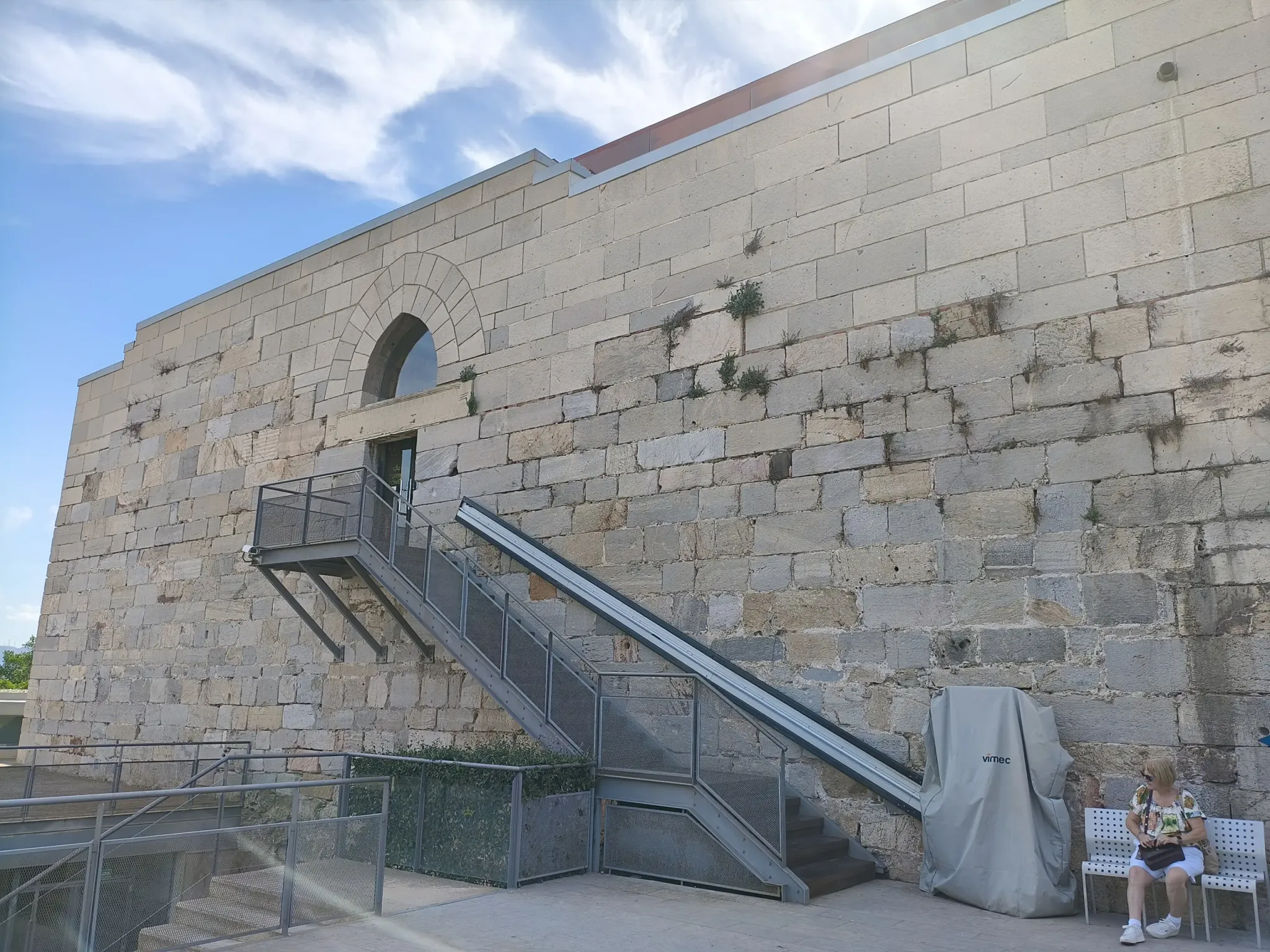 Stone exterior of the castle keep and its metal access steps