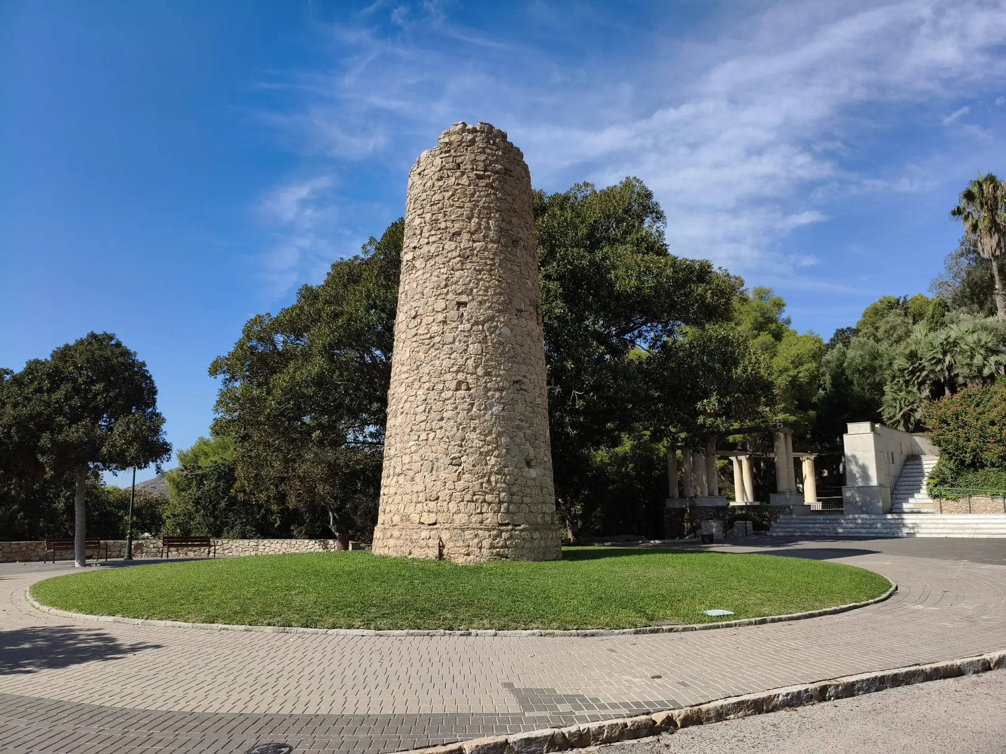 Round stone tower beside the paths of Parque Torres at Concepción Castle