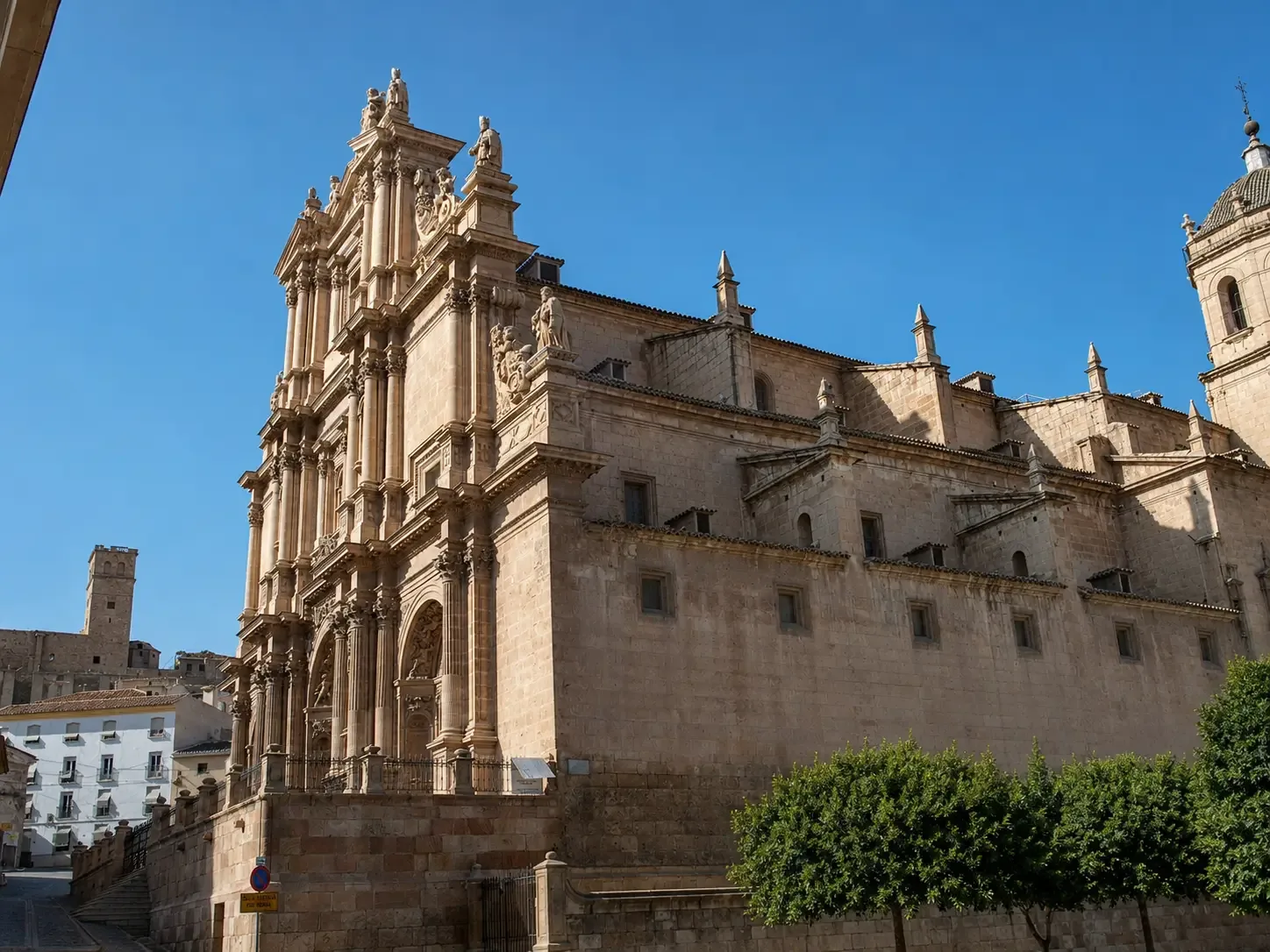 Ornate stone church in Lorca's historic centre beneath a clear blue sky