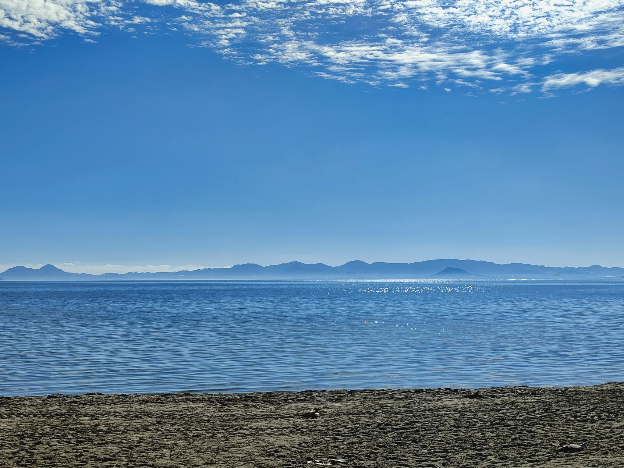 Calm blue water at Playa de Las Salinas with hills across the Mar Menor