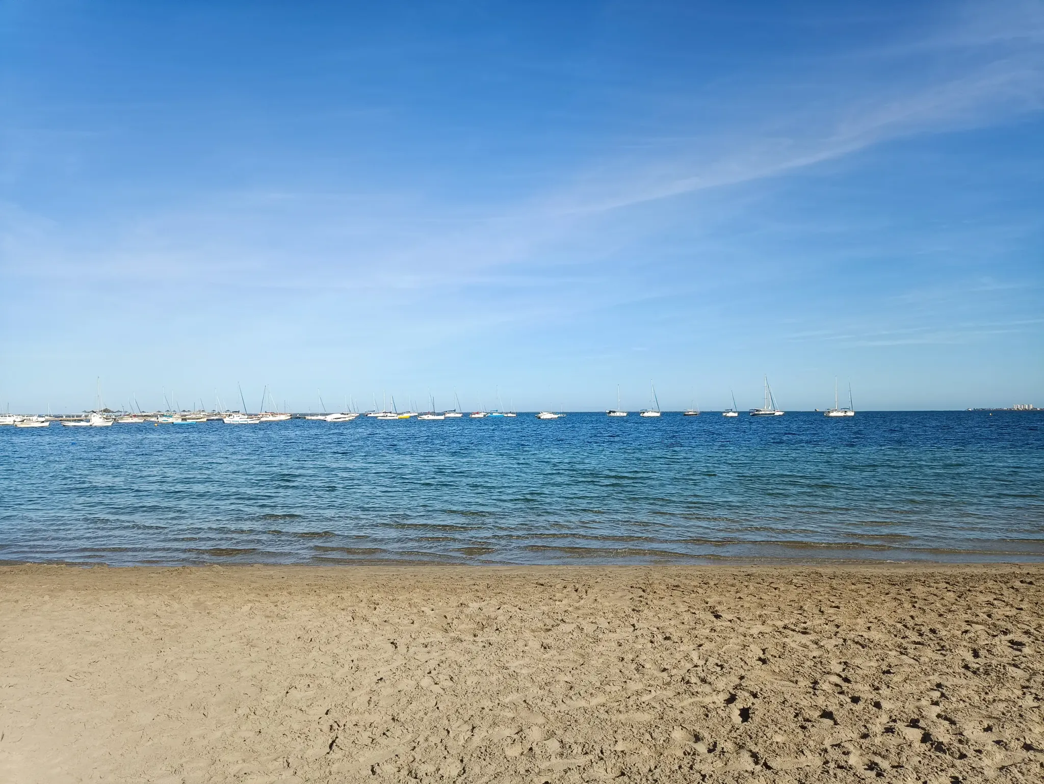 Sandy Mar Menor beach in San Javier with sailboats anchored offshore